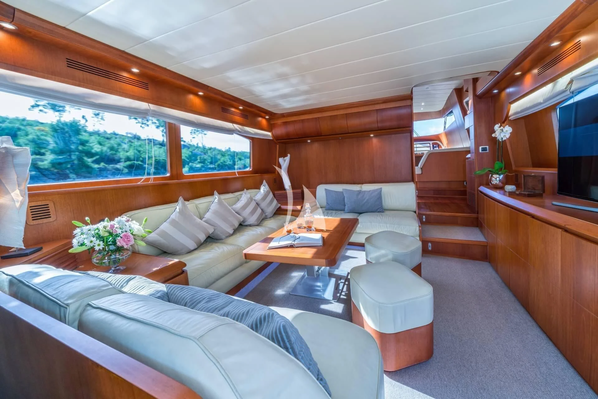 a living room with a large window aboard JANTAR Yacht for Charter