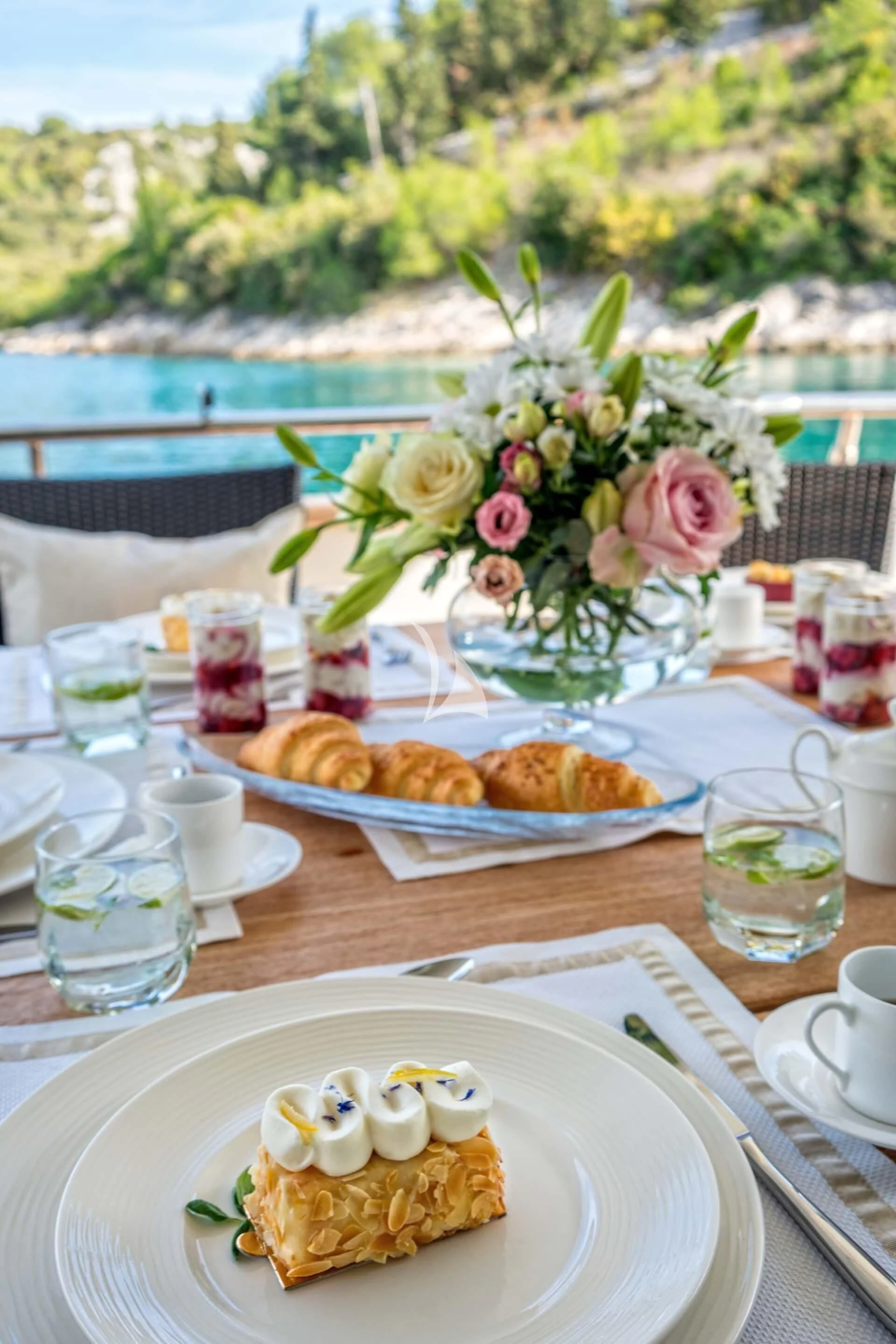 a table with food and drinks on it aboard JANTAR Yacht for Charter
