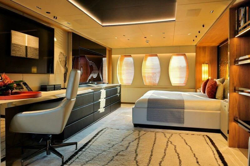 a room with a bed and desk aboard SEAHORSE Yacht for Sale