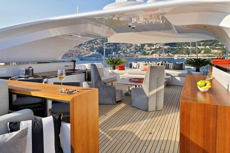 a room with a table chairs and a view of a city aboard SEAHORSE Yacht for Sale