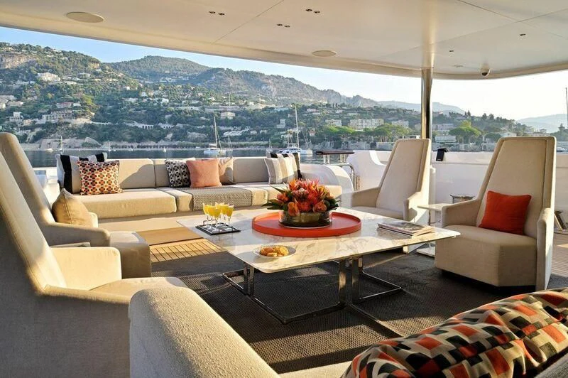 a living room with a table and chairs aboard SEAHORSE Yacht for Sale