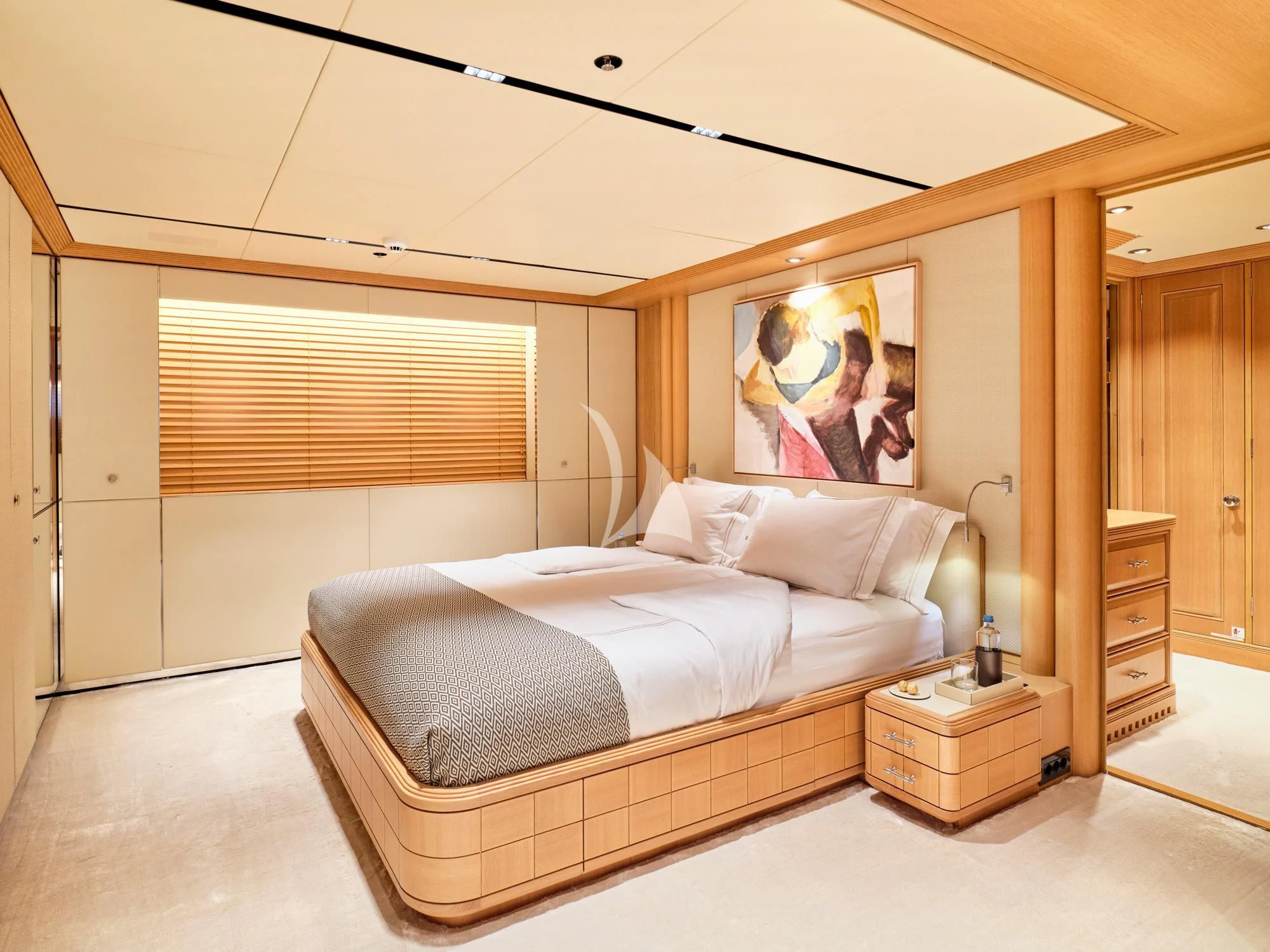 a bedroom with a bed and a painting on the wall aboard SEAHORSE Yacht for Sale