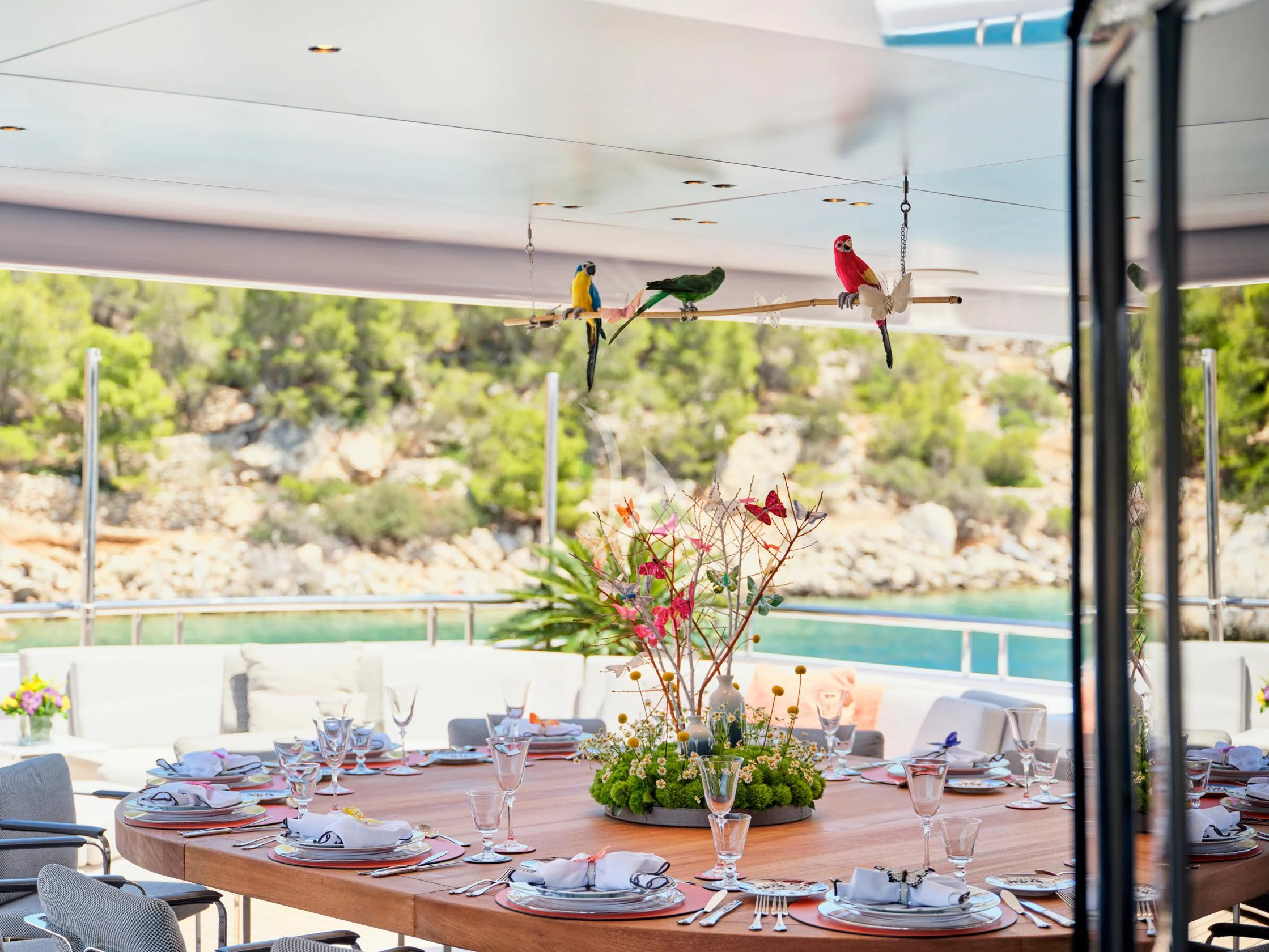 a table with plates and flowers aboard SEAHORSE Yacht for Sale