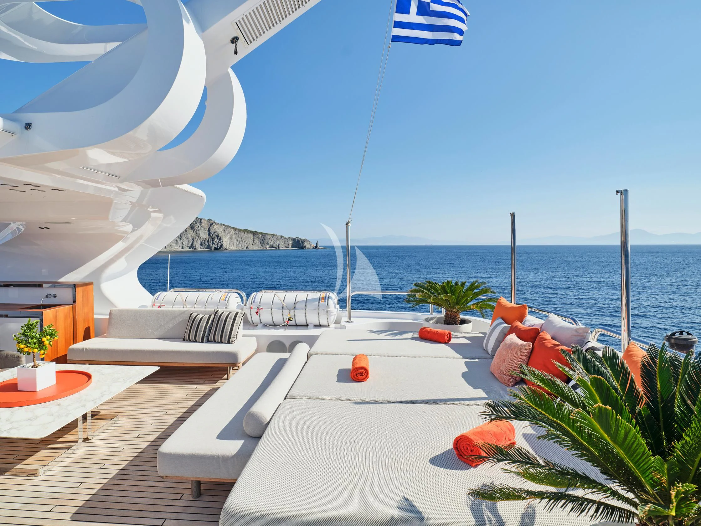 a deck with a pool and a beach and water in the background aboard SEAHORSE Yacht for Sale