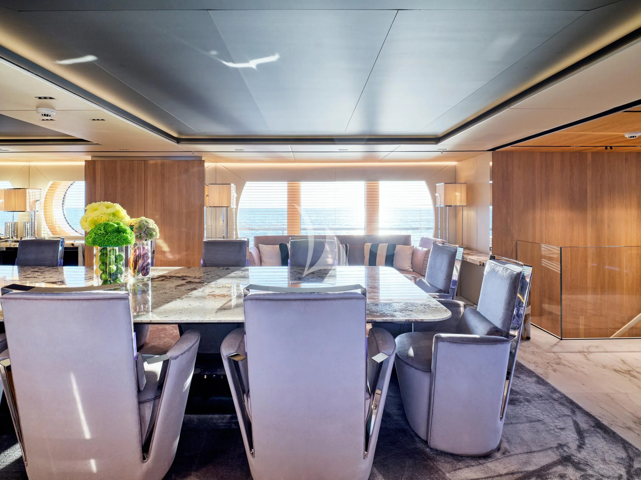 a room with a table chairs and a vase with flowers in it aboard SEAHORSE Yacht for Sale