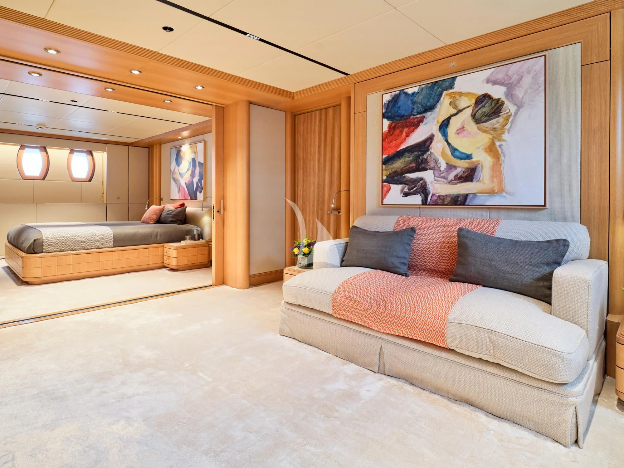 a living room with a couch and a large mirror aboard SEAHORSE Yacht for Sale