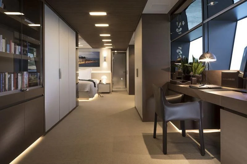 a room with a desk and a bed aboard SEVEN SINS Yacht for Sale
