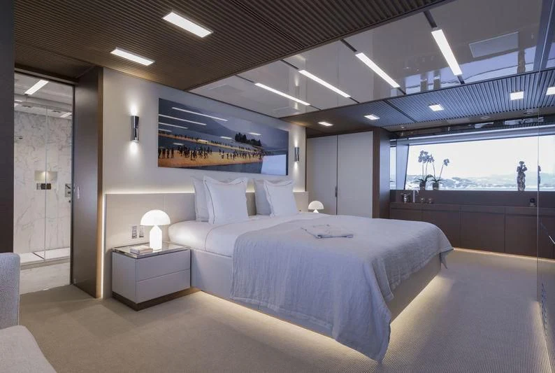 a room with a bed and a desk aboard SEVEN SINS Yacht for Sale