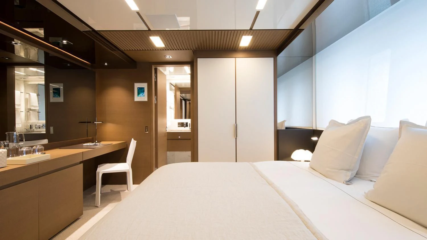 a hotel room with a bed and desk aboard SEVEN SINS Yacht for Sale