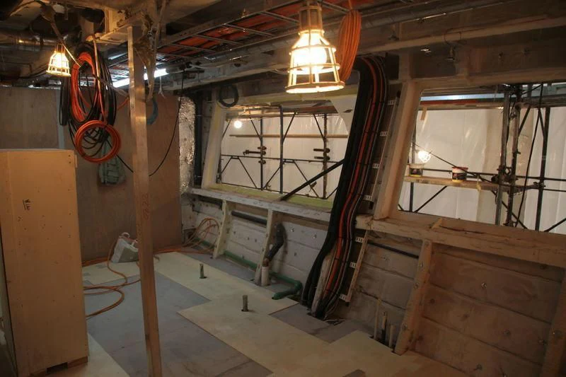 a room with wooden furniture aboard SEVEN SINS Yacht for Sale