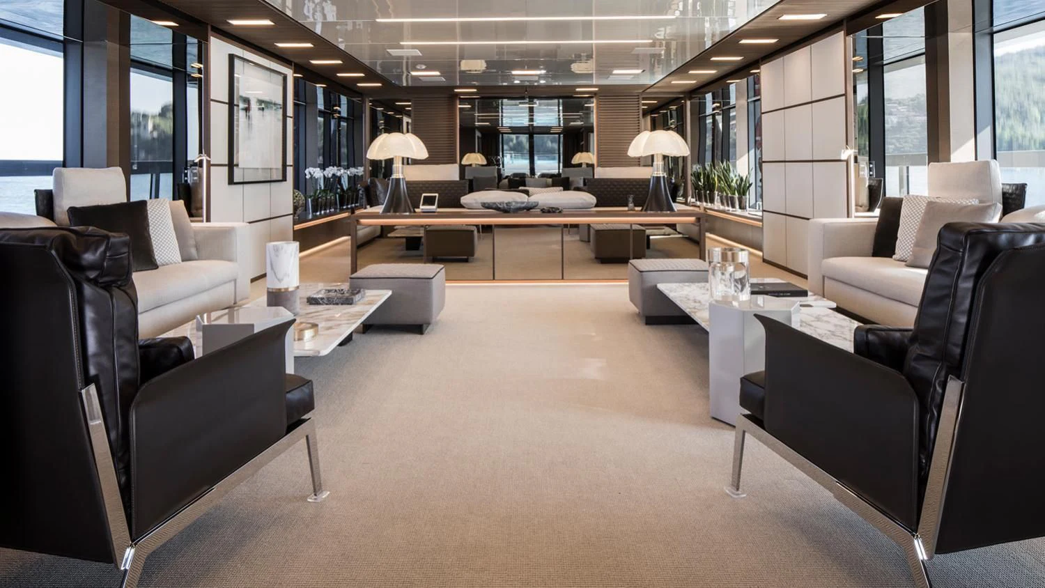 a large living room with leather couches and a large window aboard SEVEN SINS Yacht for Sale
