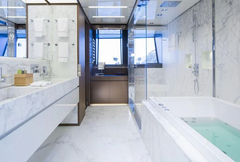 a bathroom with a tub sink and a sink aboard SEVEN SINS Yacht for Sale