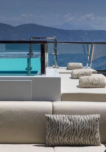 a room with a couch and a pool aboard SEVEN SINS Yacht for Sale