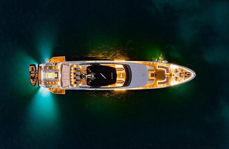 a gold lighter with a green background aboard SEVEN SINS Yacht for Sale