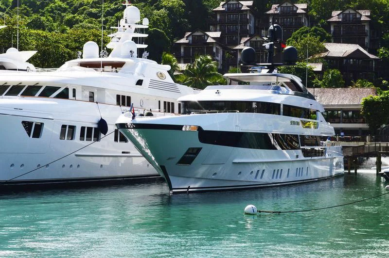 a couple of boats in a harbor aboard SEVEN SINS Yacht for Sale