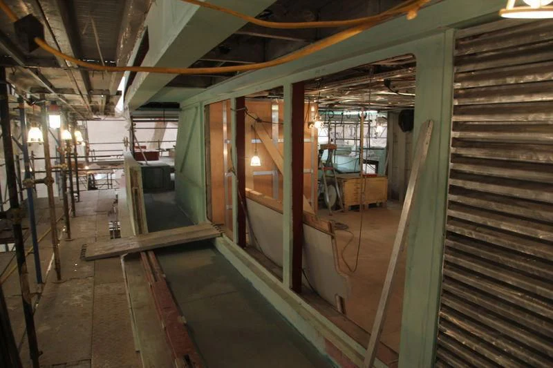 a long hallway with a glass door aboard SEVEN SINS Yacht for Sale