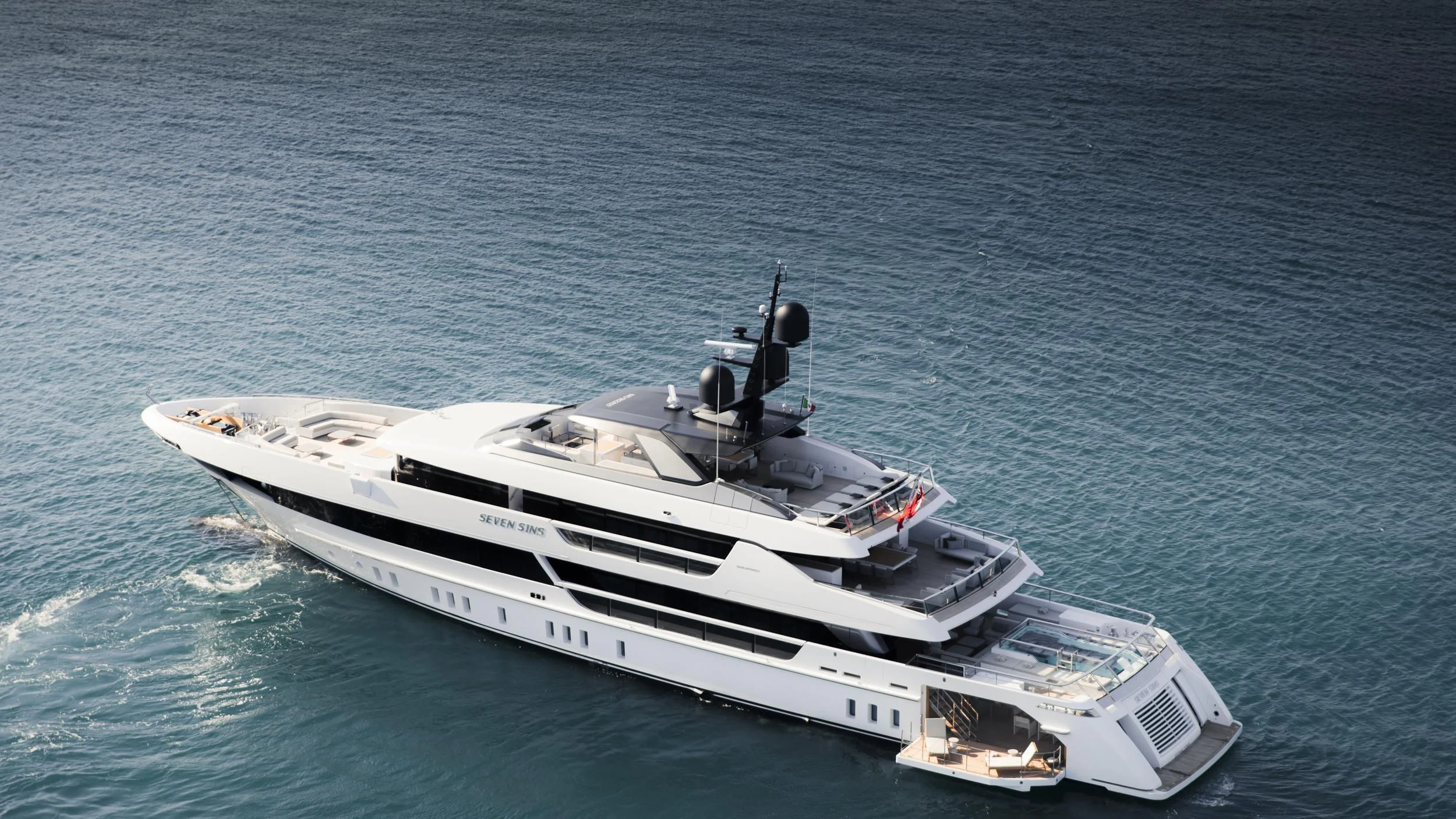 a white and black boat on the water aboard SEVEN SINS Yacht for Sale