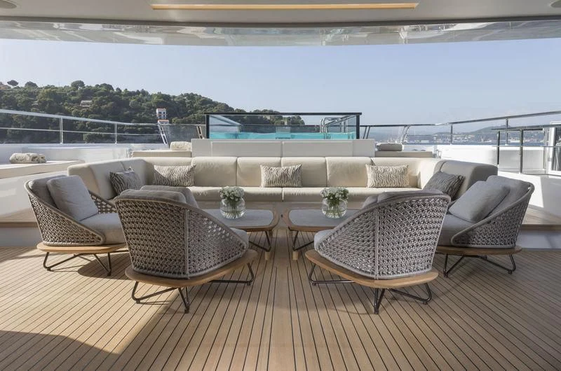 a room with a table and chairs aboard SEVEN SINS Yacht for Sale