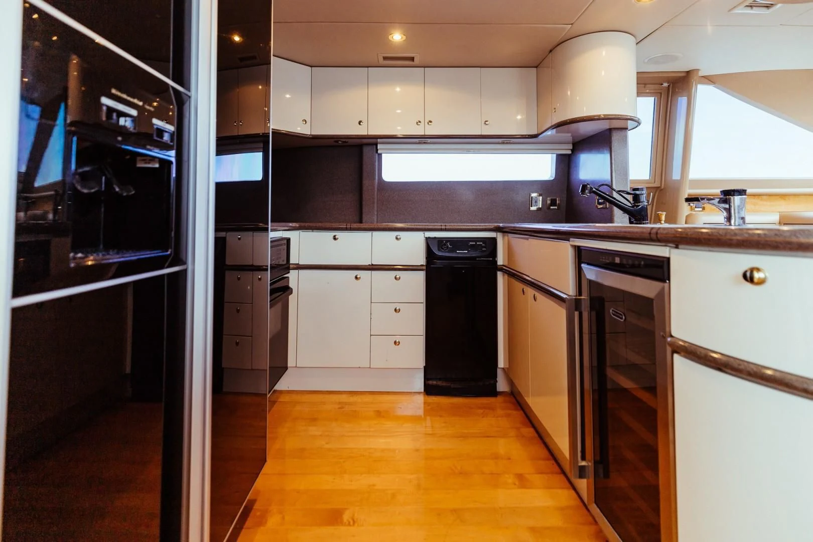 a kitchen with black appliances aboard DOUBLE EAGLE Yacht for Sale