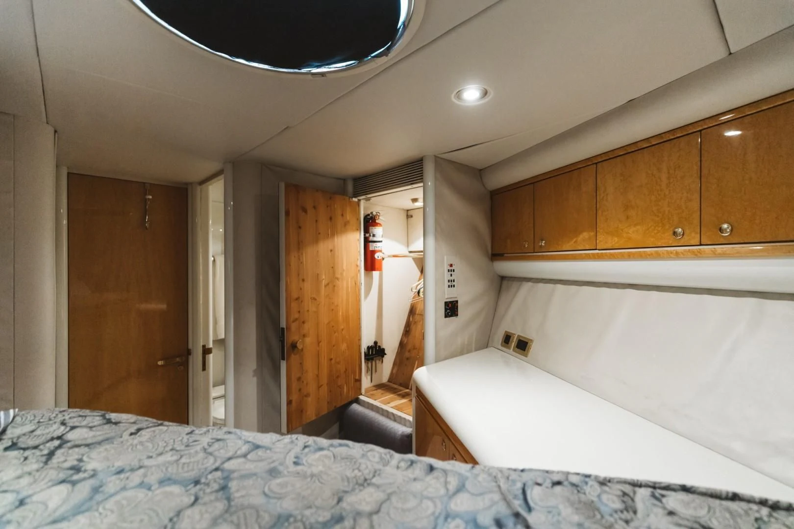 a room with a bed and a wood cabinet aboard DOUBLE EAGLE Yacht for Sale