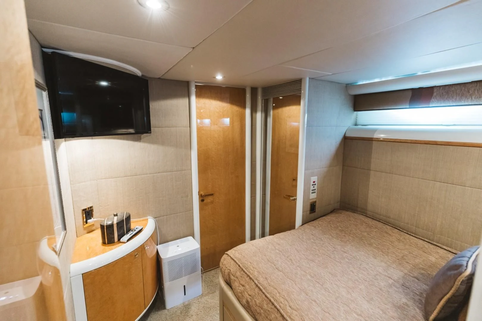 a hotel room with a bed and tv aboard DOUBLE EAGLE Yacht for Sale