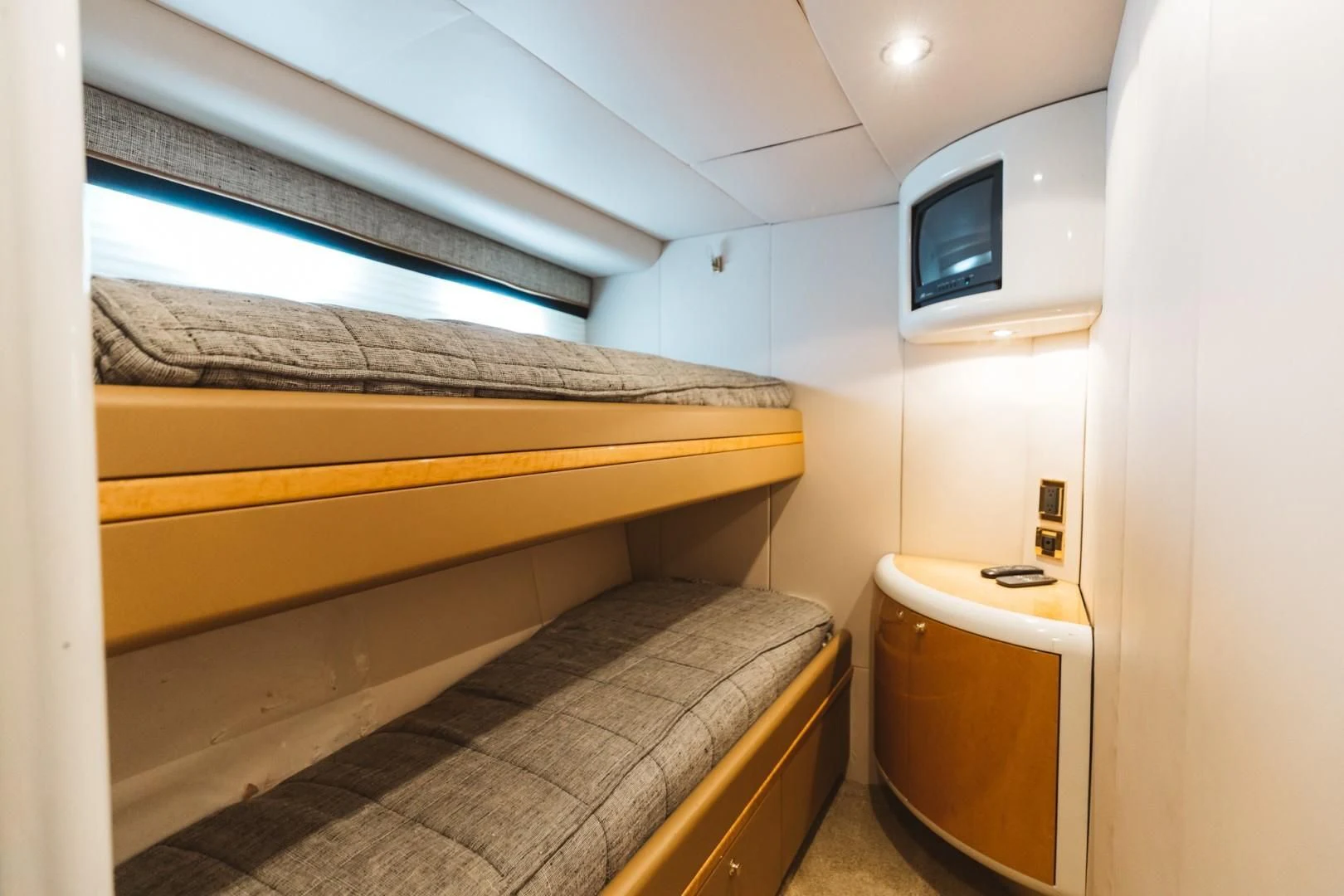 a small room with a bed and a television aboard DOUBLE EAGLE Yacht for Sale