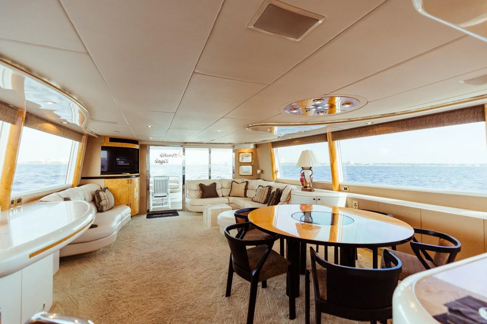 a living room with a dining table and a couch aboard DOUBLE EAGLE Yacht for Sale