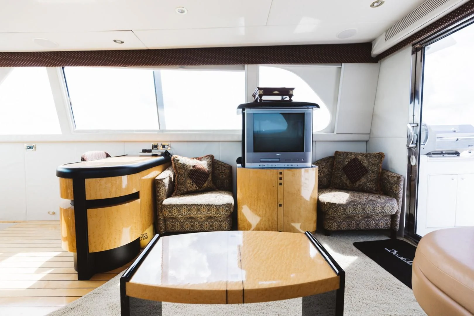 a living room with a tv and a table aboard DOUBLE EAGLE Yacht for Sale