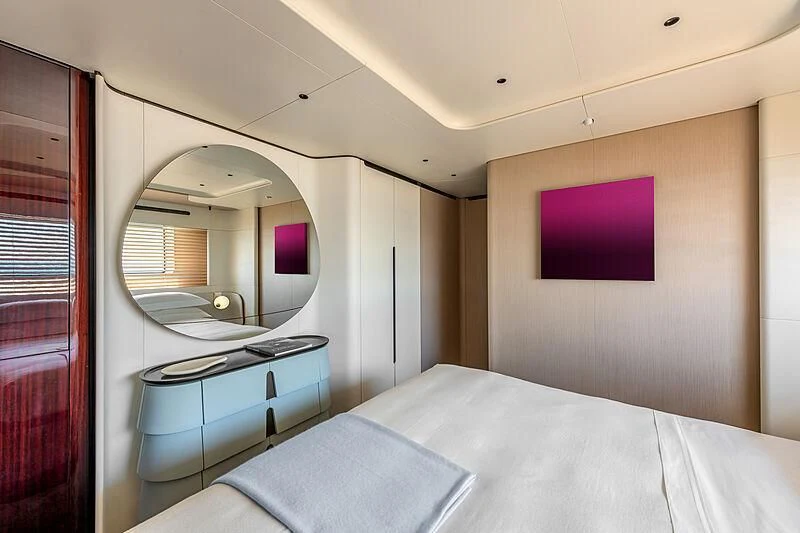 a bedroom with a bed and a mirror aboard SHABBY Yacht for Sale