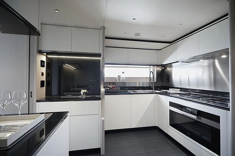 a kitchen with white cabinets aboard SHABBY Yacht for Sale