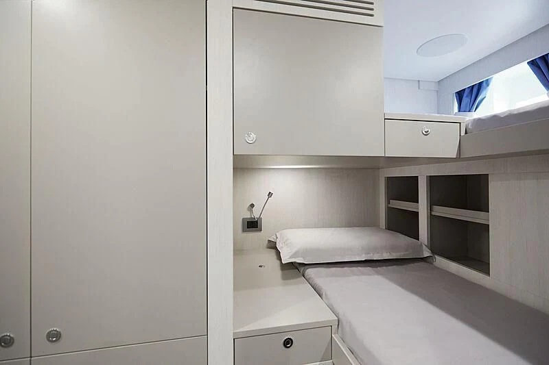 a room with a bed and cabinets aboard SHABBY Yacht for Sale