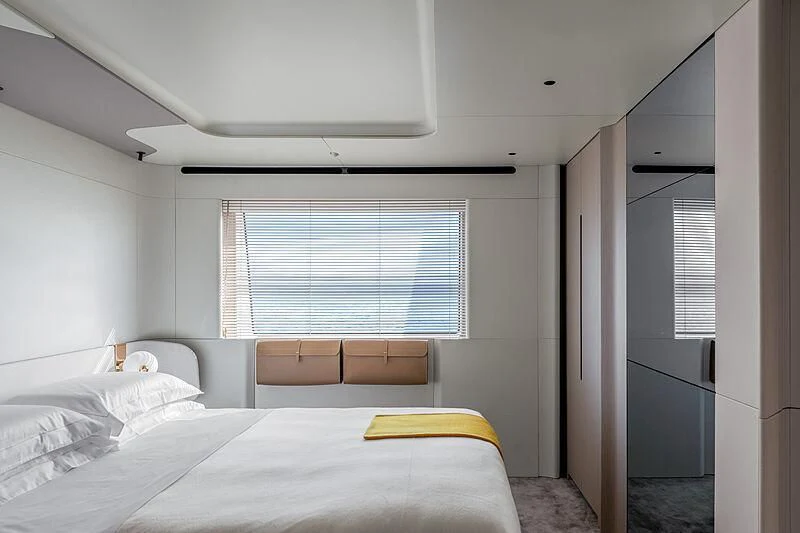 a bedroom with a bed and a window aboard SHABBY Yacht for Sale