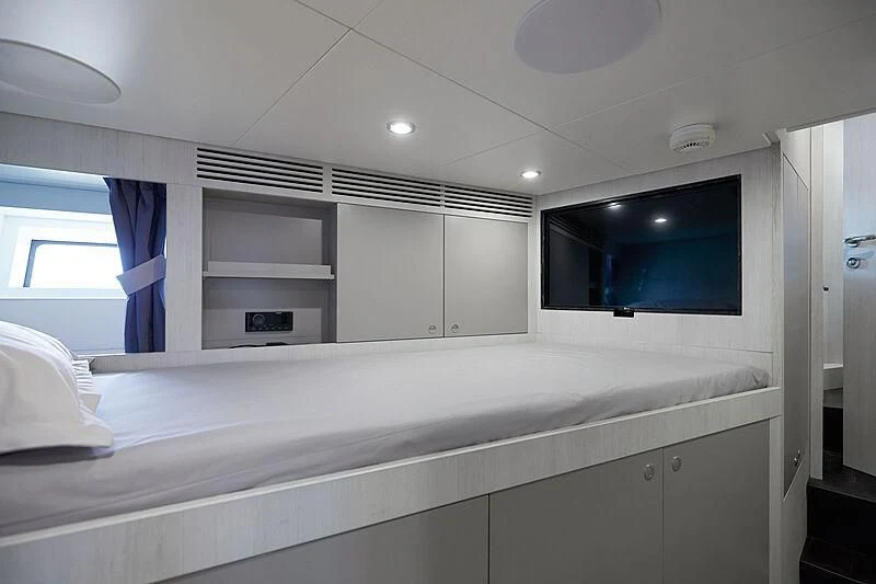 a room with a bed and a television aboard SHABBY Yacht for Sale