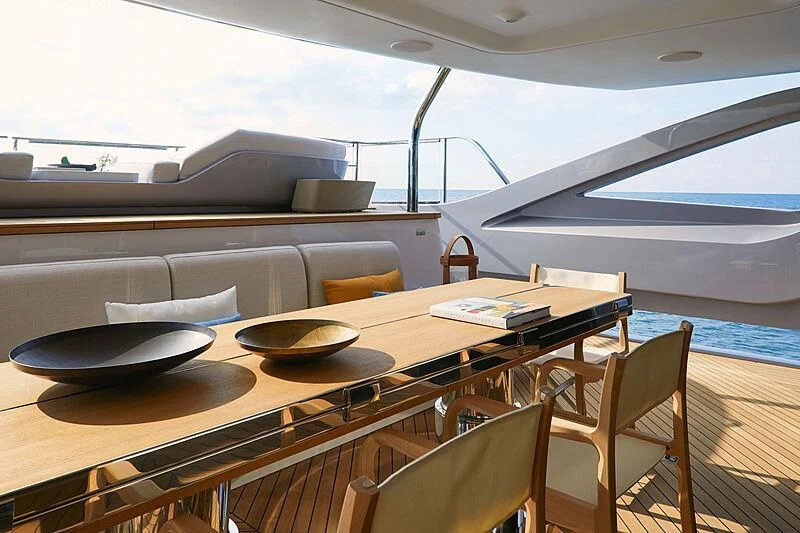 a table with chairs and a pool aboard SHABBY Yacht for Sale