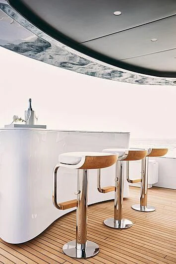 a table with stools and a glass bottle on it aboard SHABBY Yacht for Sale