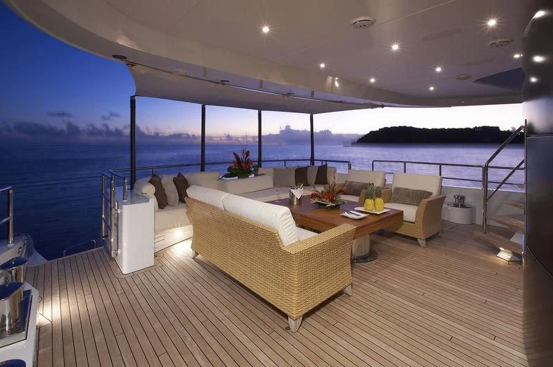 a room with a couch and a table and a view of the ocean aboard ANGKALIA Yacht for Sale