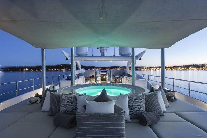 a large lounge chair on a deck overlooking a body of water aboard ANGKALIA Yacht for Sale