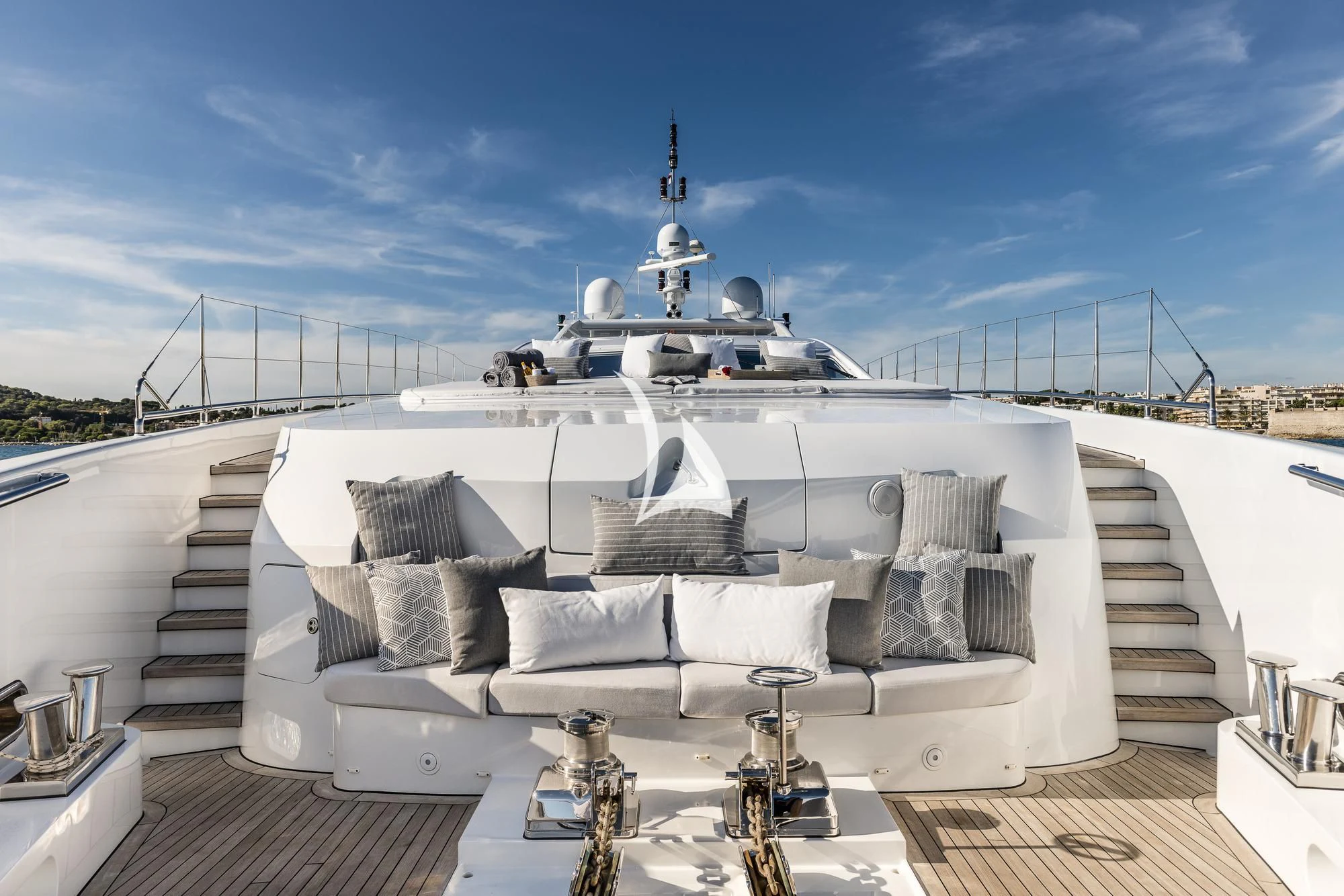 a large white boat with a white roof and a white pillow on a deck with a blue sky aboard ANGKALIA Yacht for Sale