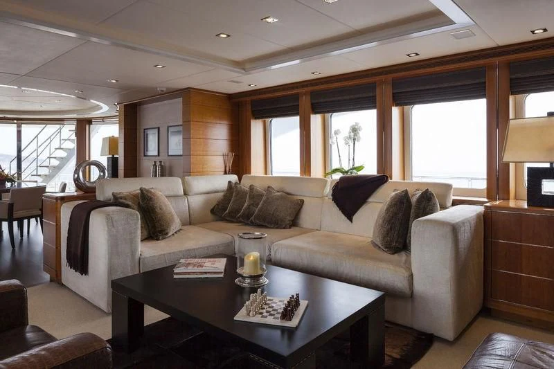 a living room with a couch and a coffee table aboard ANGKALIA Yacht for Sale