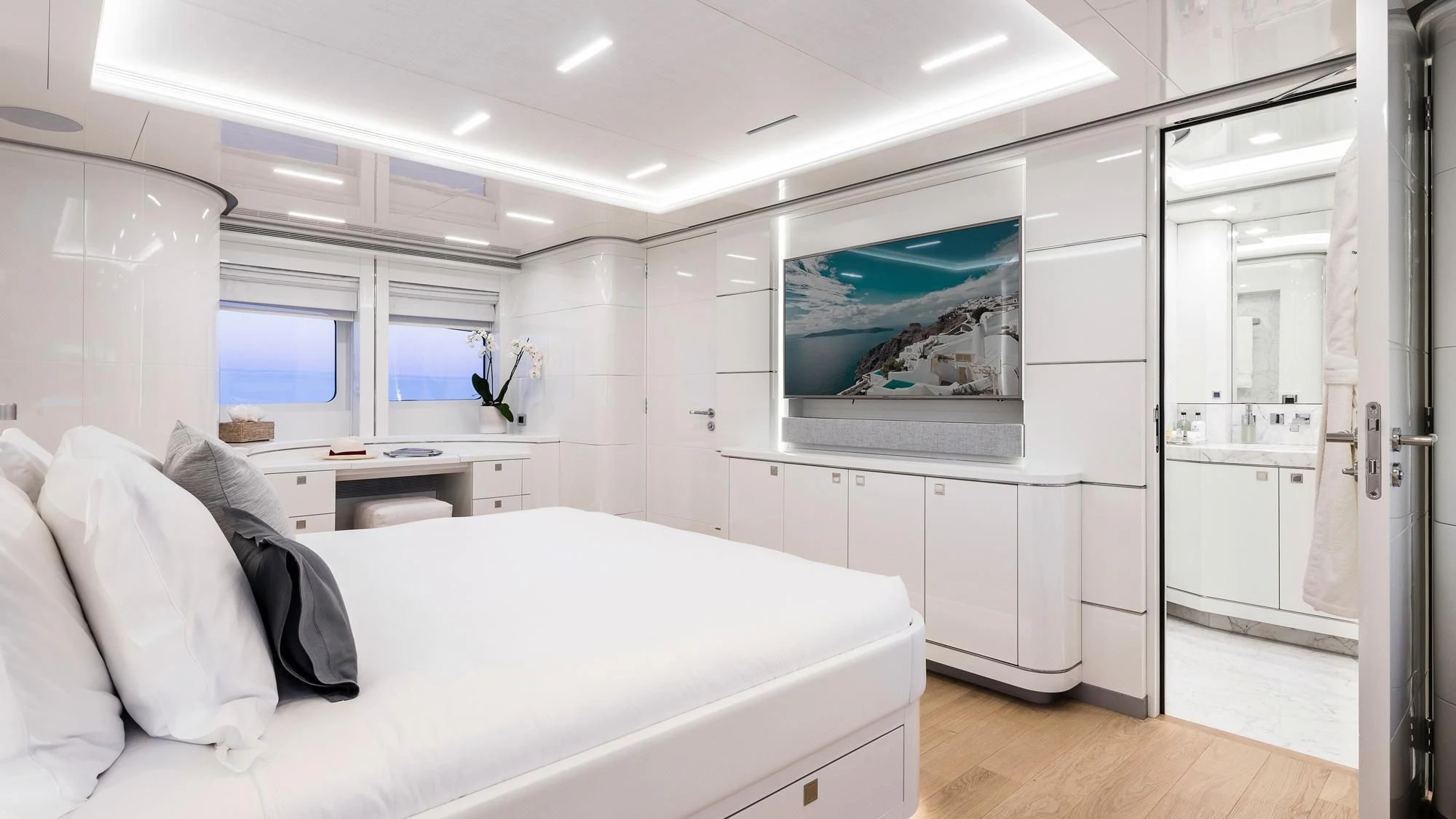 a white bedroom with a bed aboard ANGKALIA Yacht for Sale
