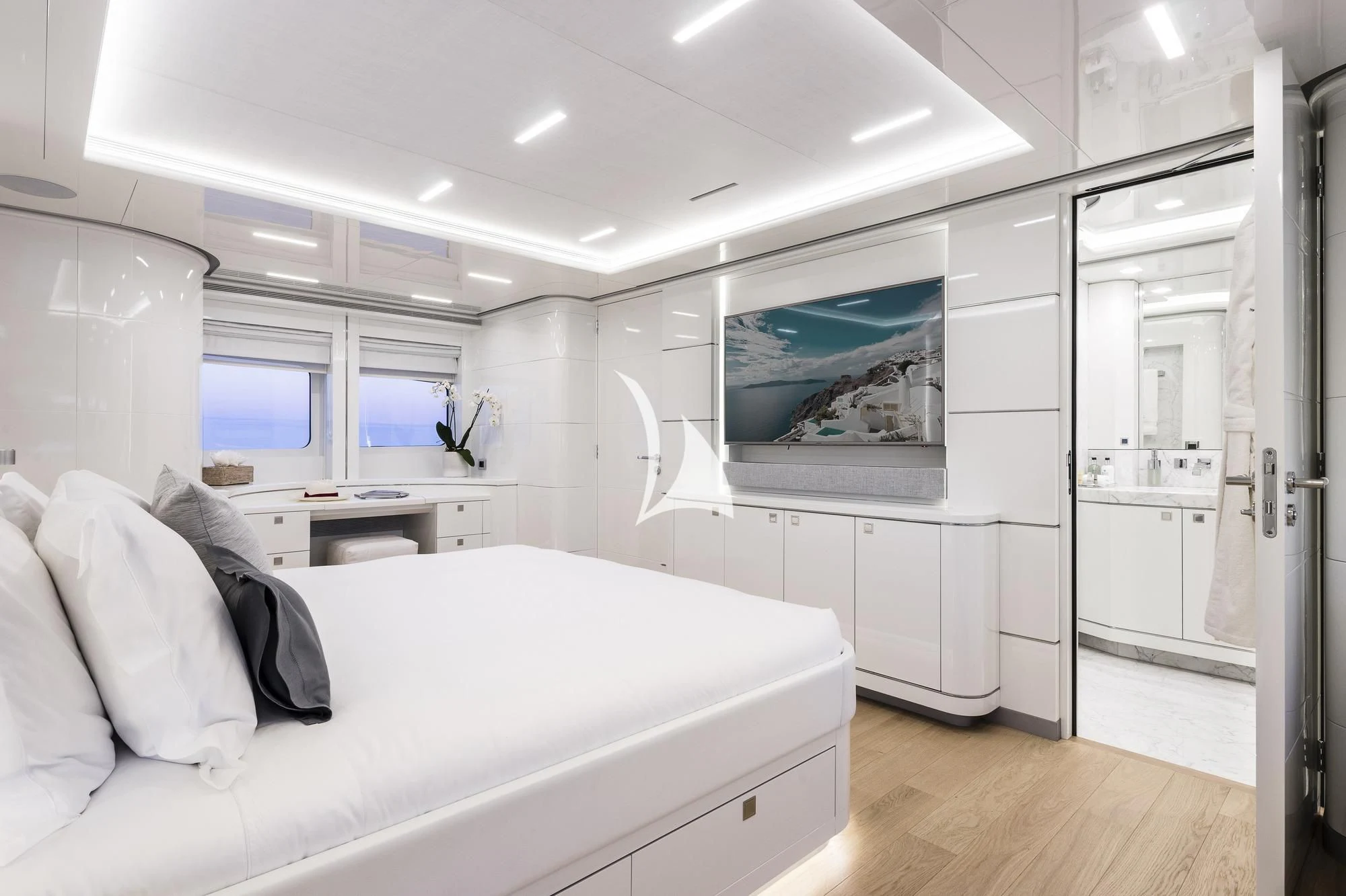 a white bedroom with a large bed aboard ANGKALIA Yacht for Sale