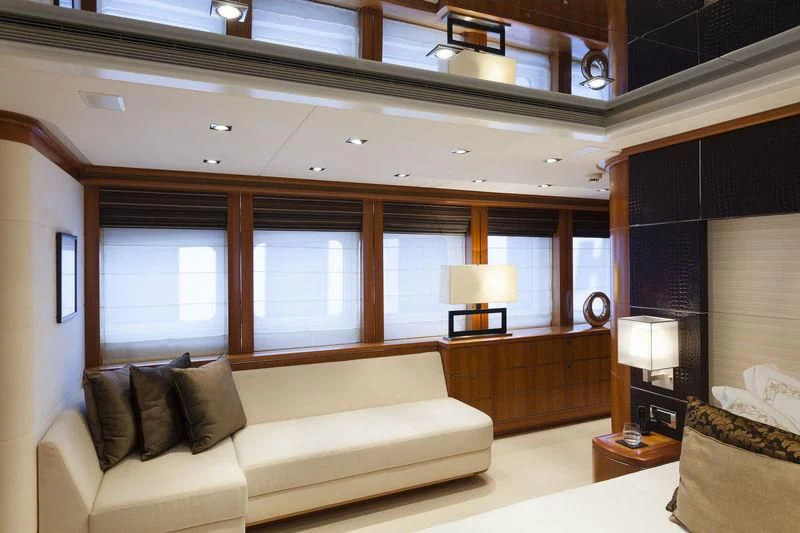a living room with a couch and a large window aboard ANGKALIA Yacht for Sale