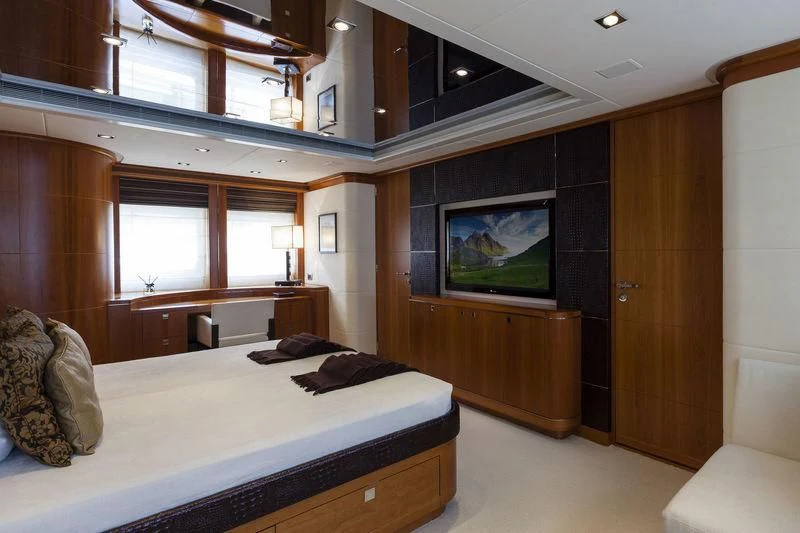 a bedroom with a bed and a television aboard ANGKALIA Yacht for Sale