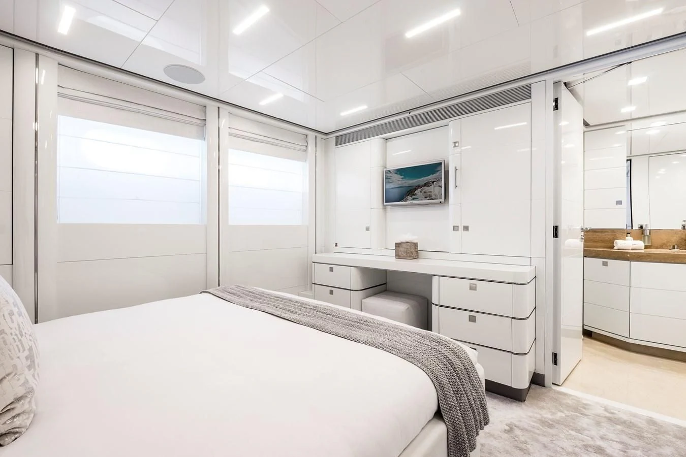 a white bedroom with a bed aboard ANGKALIA Yacht for Sale