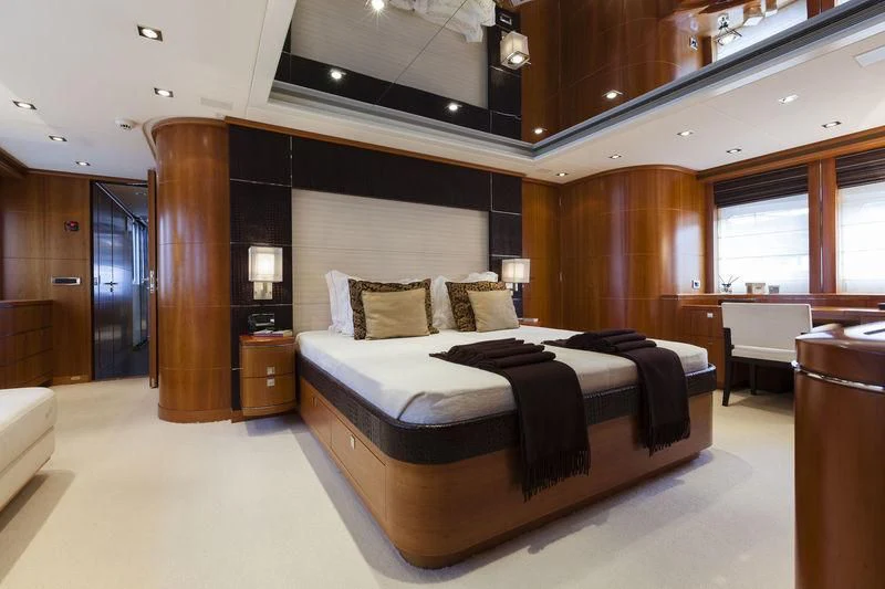 a large bedroom with a large bed aboard ANGKALIA Yacht for Sale