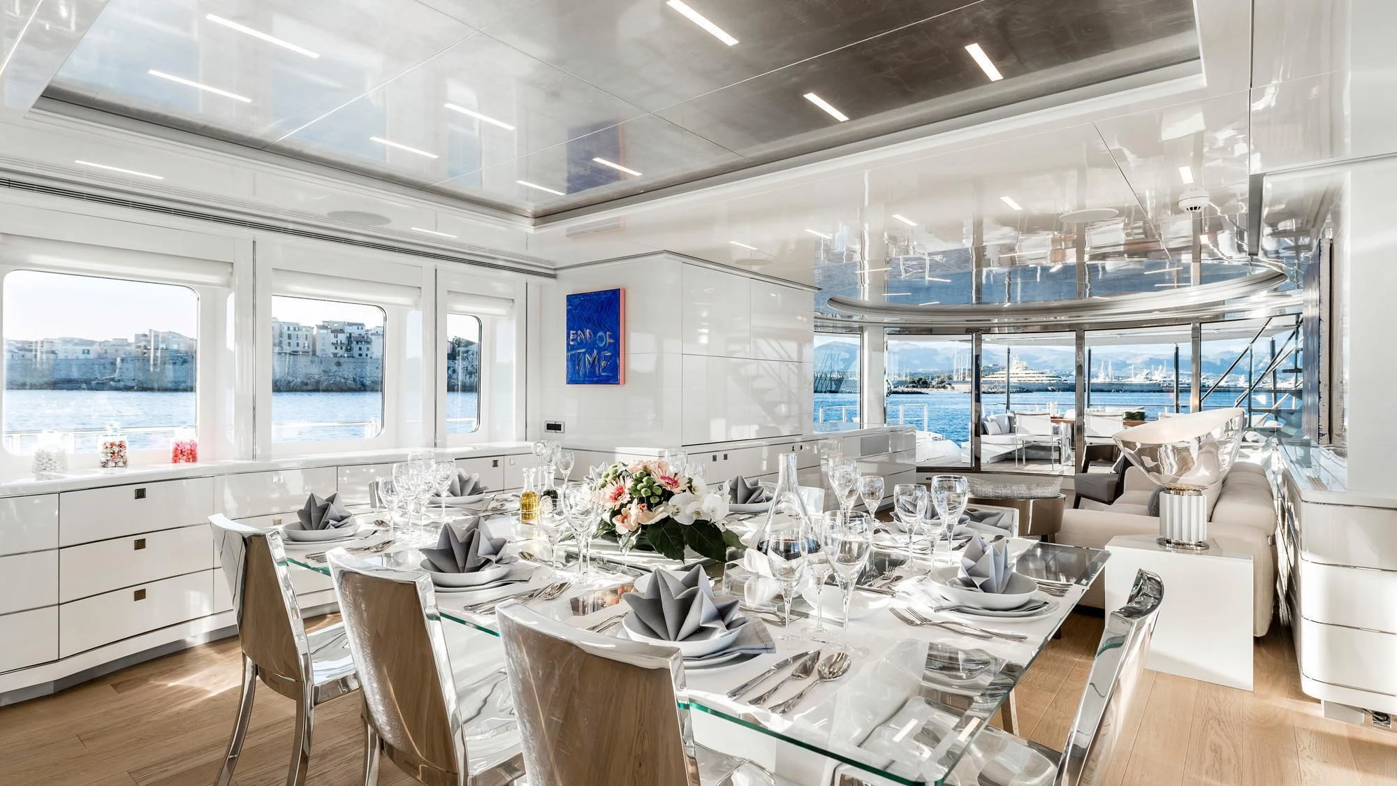 a room with tables and chairs aboard ANGKALIA Yacht for Sale