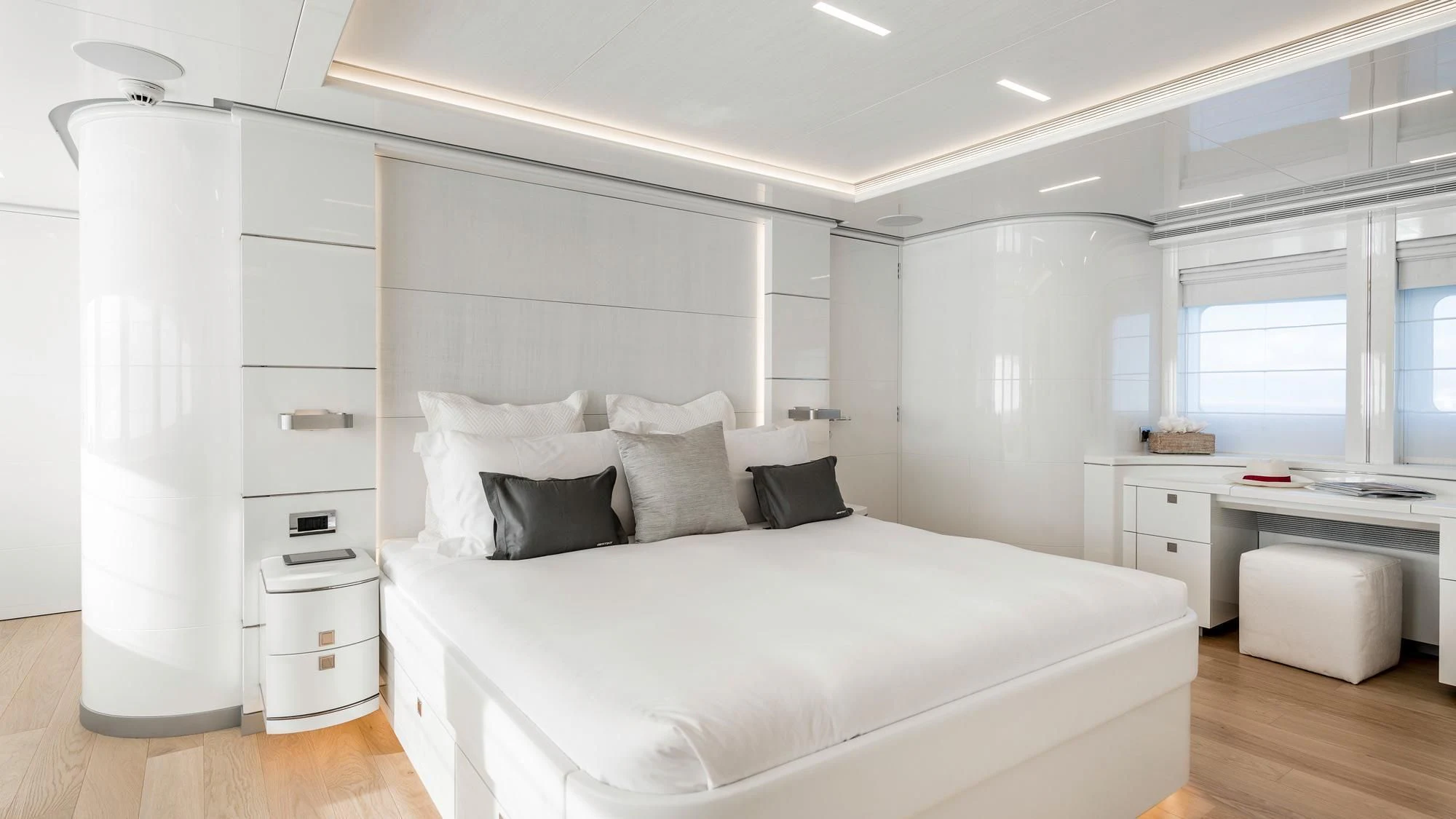 a white bedroom with a bed aboard ANGKALIA Yacht for Sale
