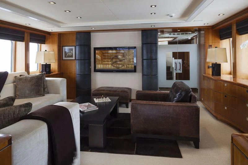 a living room with a couch and a television aboard ANGKALIA Yacht for Sale