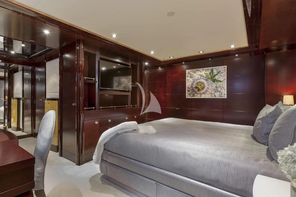 a bedroom with a bed and a desk aboard TRENDING Yacht for Sale