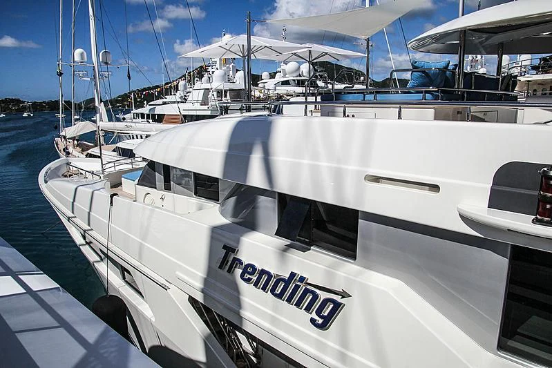 a white yacht in a dock aboard TRENDING Yacht for Sale